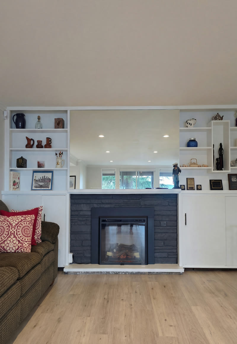 Finished living room with fireplace and built-in shelving — Gold Remodeling, BQ Productions